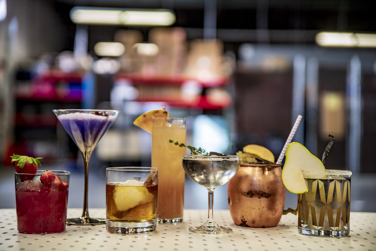 An assortment of colorful cocktails displayed on a bar counter.